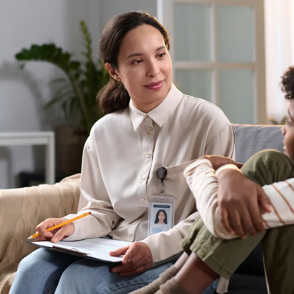 female psychologist talking to young child