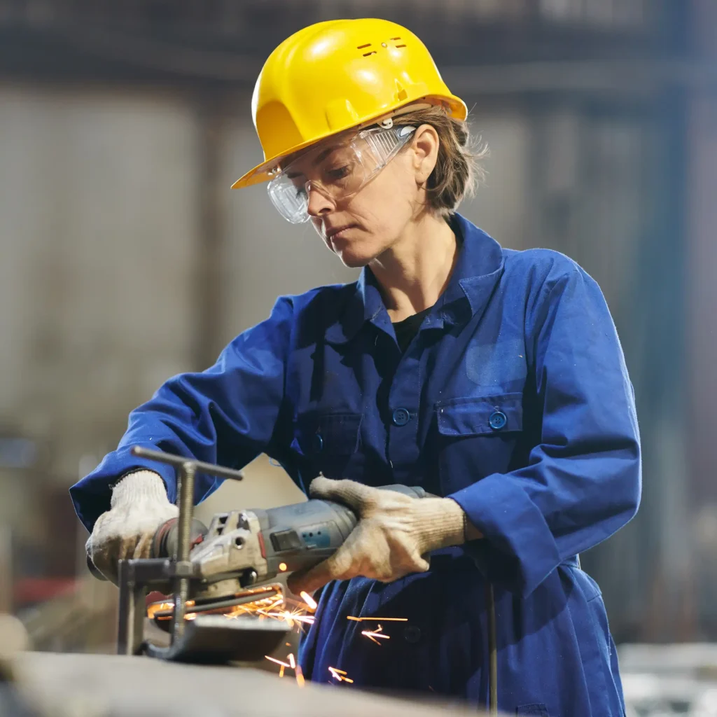 female worker cutting metal